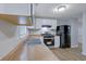 Kitchen featuring stainless steel appliances, neutral countertops, and wood-look flooring at 5295 Old Trail Cir, Stone Mountain, GA 30088