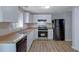 Kitchen with stainless steel appliances, white cabinets and neutral countertops at 5295 Old Trail Cir, Stone Mountain, GA 30088