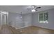 Living room showcasing wood floors, ceiling fan, and natural light from a window at 5295 Old Trail Cir, Stone Mountain, GA 30088