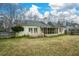 Back exterior of home with a screened porch and a large yard at 118 Heritage Way, Peachtree City, GA 30269
