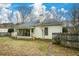Rear exterior of home with porch, large fenced-in yard and mature trees at 118 Heritage Way, Peachtree City, GA 30269