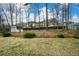Large backyard area with grass, trees and a wooden storage shed at 118 Heritage Way, Peachtree City, GA 30269