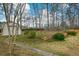 This home features a backyard with a storage shed, a lawn, and trees at 118 Heritage Way, Peachtree City, GA 30269