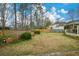 Spacious backyard with lawn, fence, and the home's rear screened porch at 118 Heritage Way, Peachtree City, GA 30269
