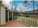 Backyard features a wooden deck and screened porch at 118 Heritage Way, Peachtree City, GA 30269