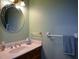 Powder room features a vanity with a marble countertop, an oval mirror, and an accent towel bar at 118 Heritage Way, Peachtree City, GA 30269