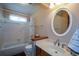 Well-lit bathroom with a tub, shower, white tile and vanity at 118 Heritage Way, Peachtree City, GA 30269