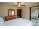 Bright bedroom boasts a full dresser, mirror, and a ceiling fan at 118 Heritage Way, Peachtree City, GA 30269