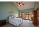 Bright bedroom features vaulted ceiling, large windows, and soft green walls at 118 Heritage Way, Peachtree City, GA 30269