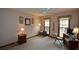 Inviting bedroom with carpet floors, side tables with lamps, and natural light at 118 Heritage Way, Peachtree City, GA 30269