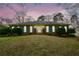 Charming brick home featuring blue shutters and manicured landscaping at dusk at 118 Heritage Way, Peachtree City, GA 30269