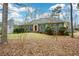 Beautiful brick home with blue shutters surrounded by mature trees at 118 Heritage Way, Peachtree City, GA 30269