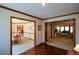 Hallway featuring hardwood floors that lead to the dining and living areas, with dark wood trim at 118 Heritage Way, Peachtree City, GA 30269