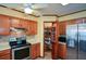 Kitchen featuring wooden cabinets, stainless steel appliances, and a pantry with spice racks at 118 Heritage Way, Peachtree City, GA 30269