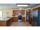 Open kitchen with stainless steel appliances, wood cabinets, and tiled backsplash at 118 Heritage Way, Peachtree City, GA 30269