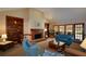 Spacious living room with fireplace, built-in bookshelves, and French doors to the exterior at 118 Heritage Way, Peachtree City, GA 30269