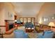 Cozy living room with a brick fireplace, vaulted ceilings, and lots of natural light at 118 Heritage Way, Peachtree City, GA 30269