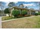 Brick home with a long driveway and a side entrance, surrounded by greenery at 118 Heritage Way, Peachtree City, GA 30269