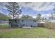 Large backyard with a covered deck, patio with outdoor furniture, and a fire pit for entertaining at 1460 Parkmont Dr, Roswell, GA 30076