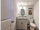 Compact bathroom with a stylish vanity, lighting, and oval mirror at 1460 Parkmont Dr, Roswell, GA 30076