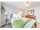 Bright bedroom with a ceiling fan, wooden dresser, and soft bedding at 1460 Parkmont Dr, Roswell, GA 30076