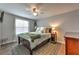 Comfortable bedroom featuring a ceiling fan, natural light, and neutral decor for a relaxing atmosphere at 1460 Parkmont Dr, Roswell, GA 30076