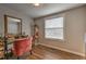 Bedroom with a desk, bright window, and hardwood flooring at 1460 Parkmont Dr, Roswell, GA 30076