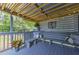 Relaxing covered deck features comfortable bench seating with decorative pillows and string lights at 1460 Parkmont Dr, Roswell, GA 30076