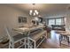 Bright dining room featuring a table with bench seating and an open floor plan into the living room at 1460 Parkmont Dr, Roswell, GA 30076