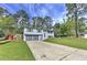 Split-level home features gray siding, an attached two-car garage, and a well-maintained lawn and driveway at 1460 Parkmont Dr, Roswell, GA 30076