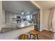 Modern kitchen featuring gray cabinets, stainless steel appliances, a breakfast bar, and hardwood floors at 1460 Parkmont Dr, Roswell, GA 30076