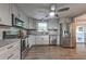 Bright kitchen with gray cabinets, stainless steel appliances, and hardwood floors at 1460 Parkmont Dr, Roswell, GA 30076