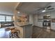 Open-concept kitchen with gray cabinets, stainless steel appliances, breakfast bar, and hardwood floors at 1460 Parkmont Dr, Roswell, GA 30076