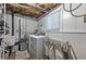 Laundry area featuring new washer and dryer with exposed ceiling and storage at 1460 Parkmont Dr, Roswell, GA 30076