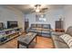 Comfortable living room featuring sofas, a ceiling fan, and entertainment center at 1460 Parkmont Dr, Roswell, GA 30076