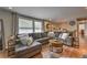 Cozy living room features a large sectional sofa, hardwood floors, and plenty of natural light at 1460 Parkmont Dr, Roswell, GA 30076