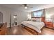 Cozy main bedroom features hardwood floors, a ceiling fan, and ample natural light at 1460 Parkmont Dr, Roswell, GA 30076