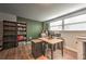 Office space with hardwood floors, shelving, and a large window at 1460 Parkmont Dr, Roswell, GA 30076