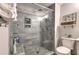 Modern shower with glass door, gray tiled walls, built-in niche, and stylish fixtures for spa-like experience at 1460 Parkmont Dr, Roswell, GA 30076