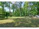 Large backyard featuring mature trees enhancing privacy and shade for outdoor enjoyment at 2162 Brookview Nw Dr, Atlanta, GA 30318