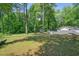 Large backyard featuring a home and mature trees enhancing privacy and shade at 2162 Brookview Nw Dr, Atlanta, GA 30318