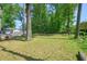 Expansive backyard with lush green grass and mature trees providing ample shade at 2162 Brookview Nw Dr, Atlanta, GA 30318