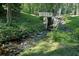 Backyard featuring a small foot bridge with lush foliage at 2162 Brookview Nw Dr, Atlanta, GA 30318
