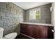 Unique bathroom with stone walls and stylish cabinetry at 2162 Brookview Nw Dr, Atlanta, GA 30318