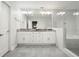 Elegant bathroom with double vanity, granite countertop, large mirrors, and glass-enclosed shower at 2162 Brookview Nw Dr, Atlanta, GA 30318