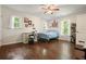 Bright bedroom featuring hardwood floors, natural light, and a blue metal bed frame at 2162 Brookview Nw Dr, Atlanta, GA 30318