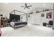 Bright bedroom featuring a king-sized bed, modern decor, a ceiling fan, and tile flooring at 2162 Brookview Nw Dr, Atlanta, GA 30318