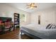 Bedroom with hardwood floors, a bed with plush bedding, and desk, with a bright window at 2162 Brookview Nw Dr, Atlanta, GA 30318