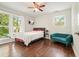 Comfortable bedroom with hardwood floors, bright windows, ceiling fan, and modern furnishings at 2162 Brookview Nw Dr, Atlanta, GA 30318