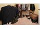 Walk-in closet with hanging clothes, shoes, and storage boxes at 2162 Brookview Nw Dr, Atlanta, GA 30318